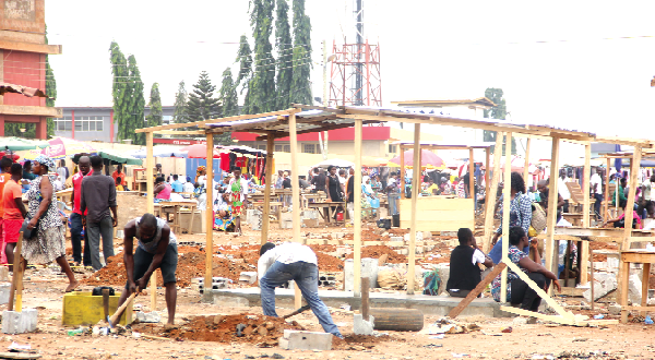 Some traders constructing structures for their wares at the Redco Market