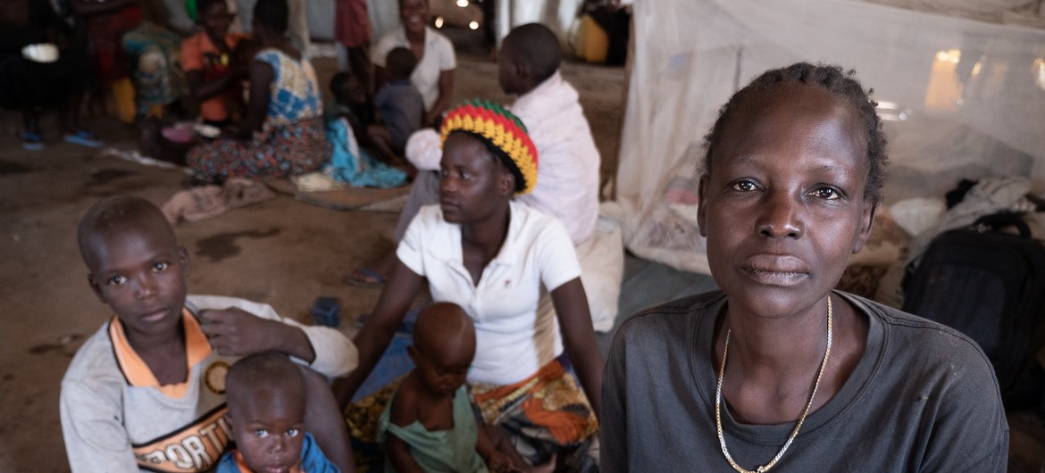 In the Democratic Republic of the Congo, Jeanette Buse Lasi, a widowed mother of four, sits with her children inside a communal shelter in an IDP camp in Bunia.